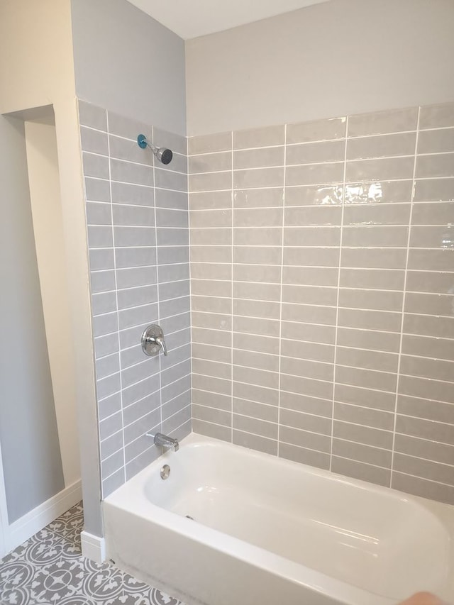 bathroom featuring tile patterned floors and tiled shower / bath