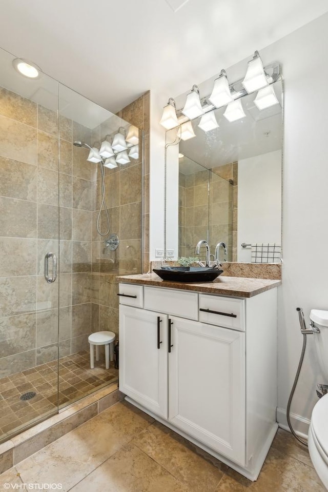 bathroom featuring tile patterned floors, vanity, toilet, and an enclosed shower