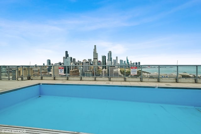 view of swimming pool featuring a water view