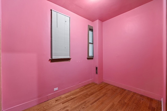 unfurnished room featuring hardwood / wood-style flooring