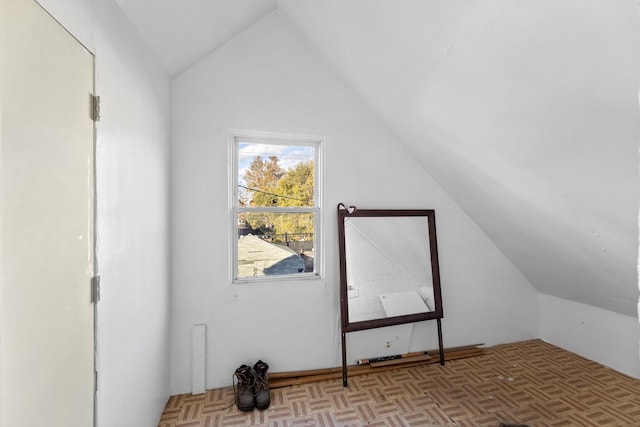 bonus room with light parquet floors and lofted ceiling