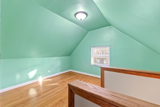 additional living space featuring hardwood / wood-style floors and lofted ceiling