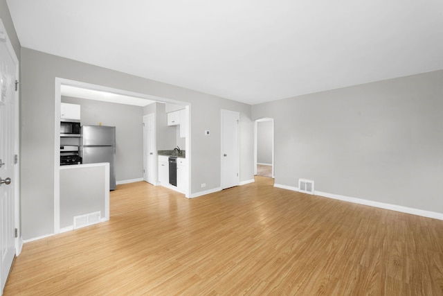 unfurnished living room with light hardwood / wood-style flooring