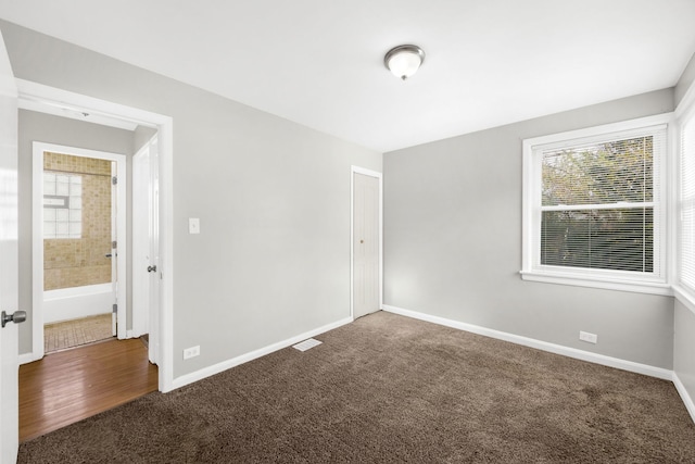 empty room with dark colored carpet