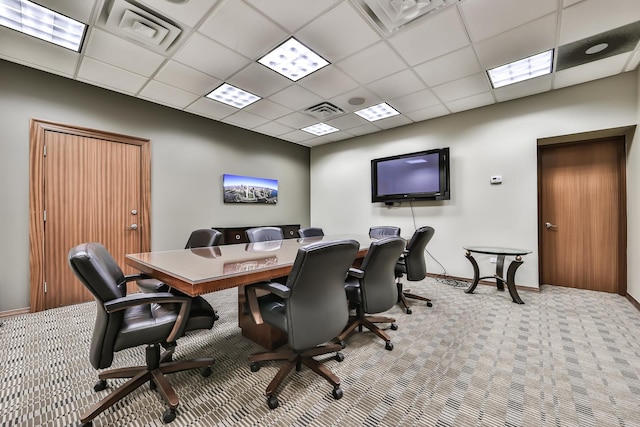 carpeted office space featuring a paneled ceiling