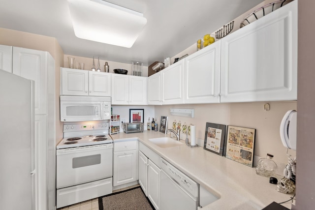 kitchen featuring white cabinets, white appliances, and sink