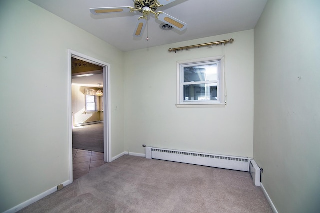 carpeted spare room with a baseboard radiator and ceiling fan