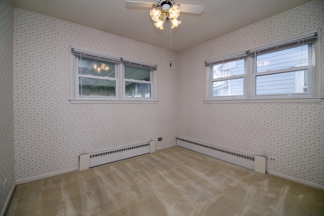 unfurnished room featuring ceiling fan, light colored carpet, and a baseboard radiator