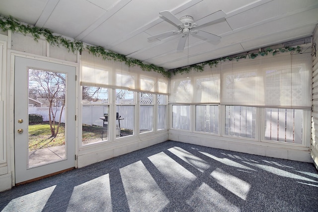 unfurnished sunroom featuring ceiling fan