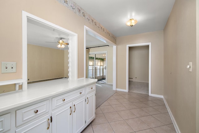 kitchen with white cabinetry, ceiling fan, and light tile patterned flooring