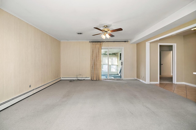 carpeted spare room with wooden walls, ceiling fan, and crown molding