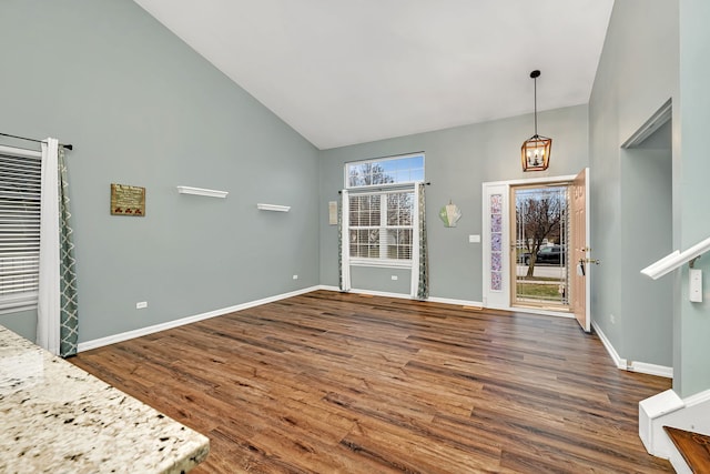 entrance foyer featuring high vaulted ceiling and dark wood-type flooring