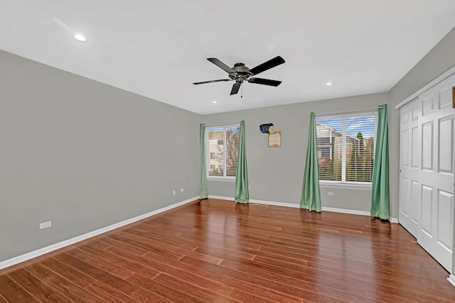 unfurnished bedroom with ceiling fan and dark hardwood / wood-style flooring