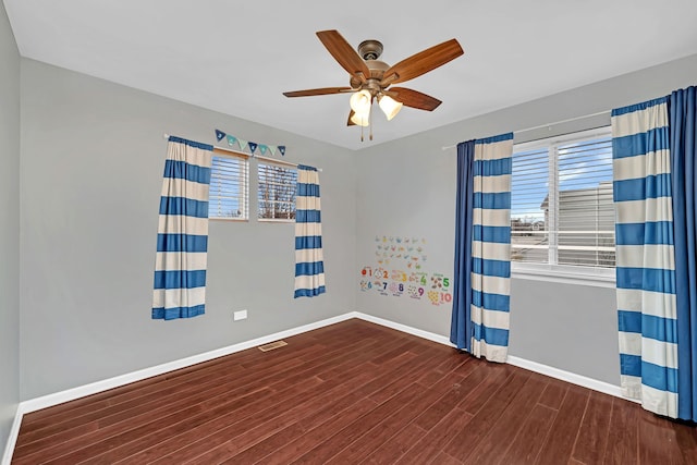 unfurnished room featuring ceiling fan and dark hardwood / wood-style floors