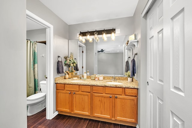 bathroom featuring ceiling fan, toilet, hardwood / wood-style flooring, vanity, and a shower with shower curtain