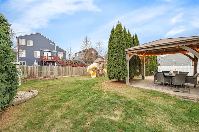 view of yard featuring a playground, a gazebo, and a patio