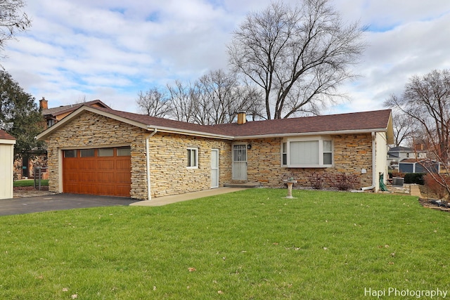 ranch-style home with a garage and a front yard