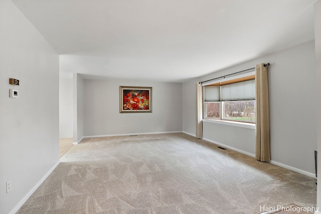 empty room featuring light carpet