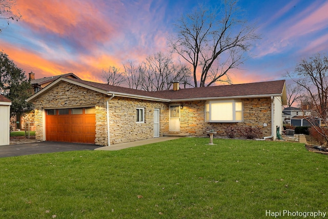 view of front of home with a lawn and a garage