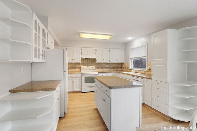 kitchen featuring white cabinetry, a kitchen island, white appliances, and light hardwood / wood-style flooring