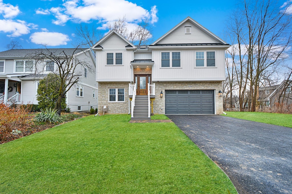 view of front of home with a garage and a front yard