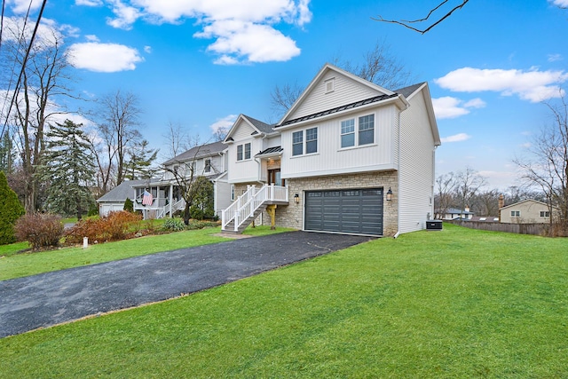 view of front of property with a front yard, a garage, and central air condition unit