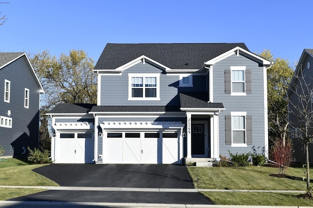 view of front of home featuring a garage and a front yard