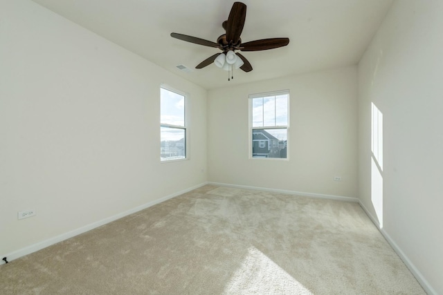 carpeted empty room featuring ceiling fan