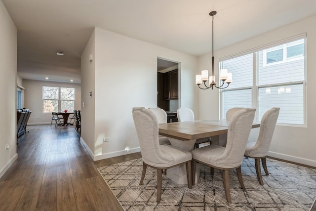 dining room with a chandelier and dark hardwood / wood-style floors