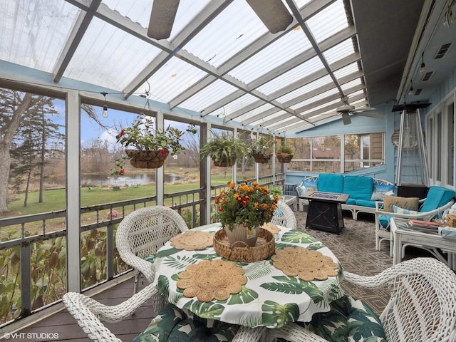 sunroom / solarium featuring ceiling fan and lofted ceiling