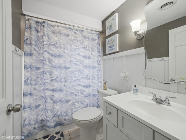 bathroom featuring tile patterned flooring, vanity, toilet, and a shower with shower curtain