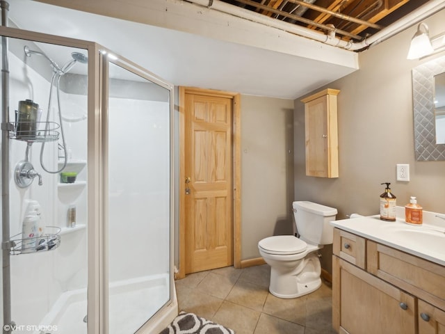 bathroom with tile patterned floors, a shower with door, vanity, and toilet