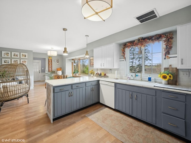 kitchen featuring gray cabinets, dishwasher, white cabinets, and a healthy amount of sunlight