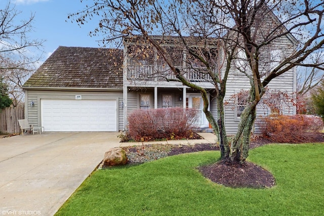 view of property with a front yard and a garage