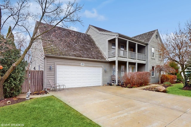 view of property featuring a garage and a balcony