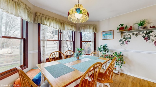 dining space with light wood-type flooring and plenty of natural light