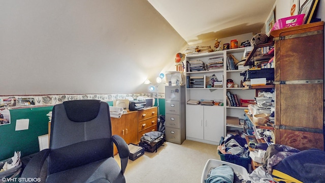 carpeted home office featuring lofted ceiling