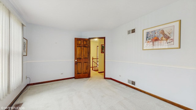 unfurnished room with light colored carpet