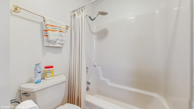 bathroom with toilet and shower / tub combo