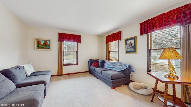 living room featuring light colored carpet and a wealth of natural light