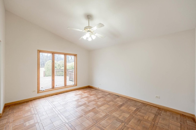 empty room with light parquet floors, vaulted ceiling, and ceiling fan