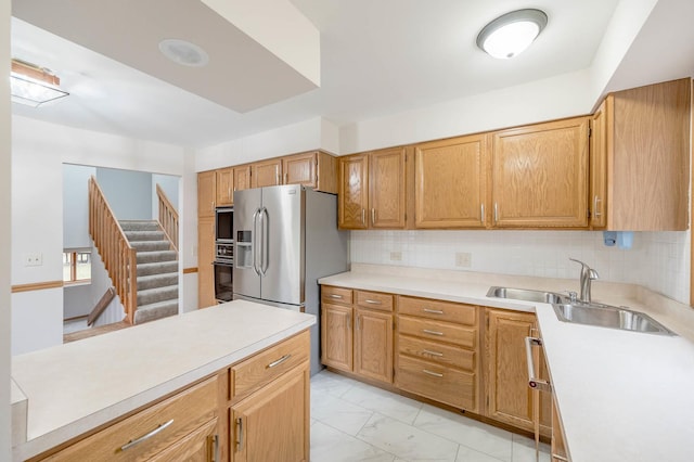 kitchen featuring black appliances, decorative backsplash, and sink