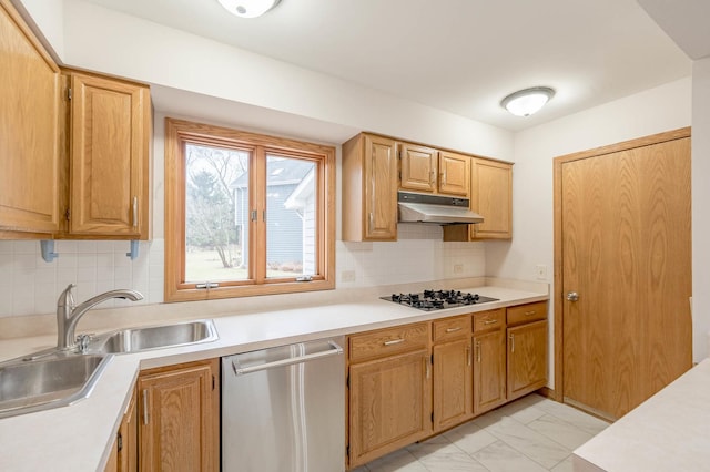 kitchen with gas cooktop, backsplash, stainless steel dishwasher, and sink