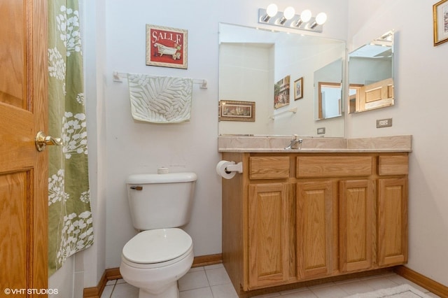 bathroom featuring tile patterned floors, vanity, and toilet