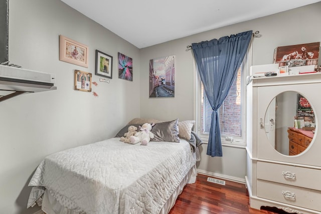 bedroom with dark wood-type flooring