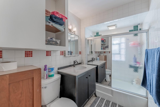 full bathroom featuring tasteful backsplash, enclosed tub / shower combo, tile walls, and toilet