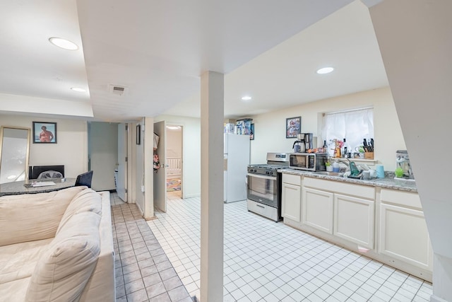 kitchen with white cabinets, stainless steel appliances, and sink