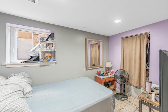 bedroom with light tile patterned floors