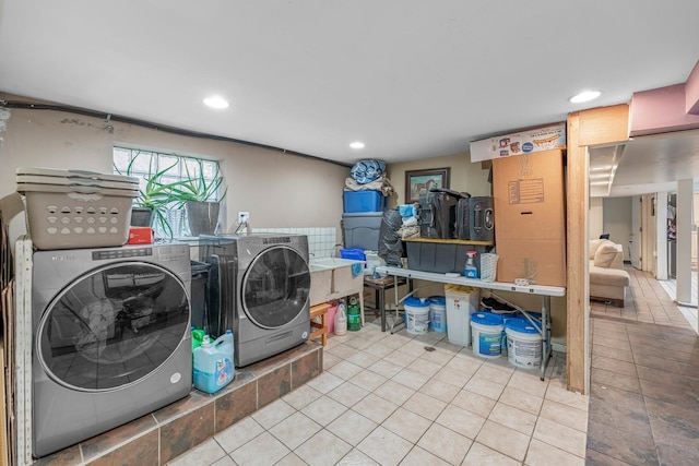 laundry area with washer and dryer and light tile patterned floors