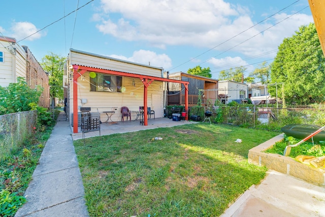 rear view of property with a patio area and a lawn